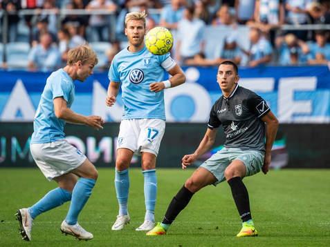 Oscar Lewicki clears the ball in front of team mate Rasmus