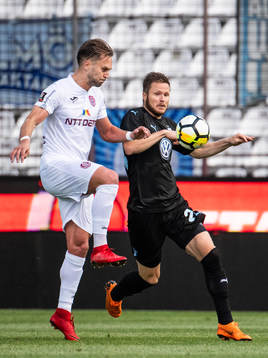 Billel Omrani of Cluj clears the ball in front of Lasse