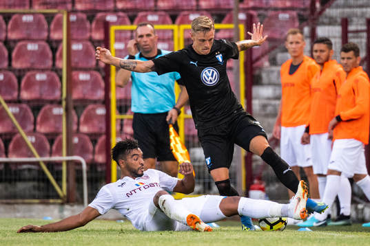 Billel Omrani of Cluj slide tackle against Sören Rieks of