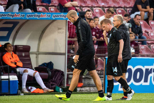 Anders Christiansen of Malmö FF is helped off the pitch by