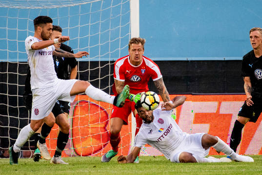 Goalkeeper Johan Dahlin of Malmö FF fight for the ball