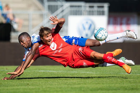 Steffen Lie Skålevik of Brann is tackled by Ben Karamoko