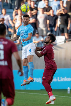 Behrang Safari of Malmö FF and Billel Omrani of Cluj