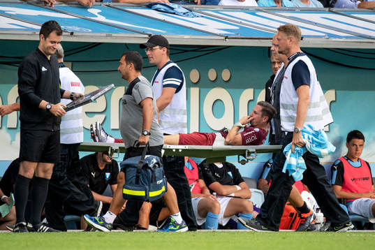 Ciprian Deac of Cluj is taken off the pitch