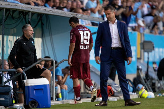 Juan Culio of Cluj leaves the pitch with a red card
