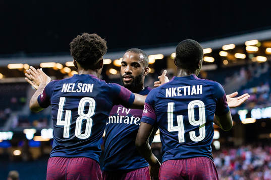 Alexandre Lacazette of Arsenal celebrates with Reiss Nelson