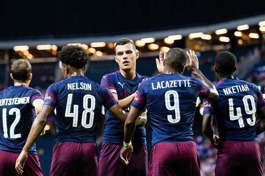 Granit Xhaka of Arsenal celebrates with Reiss Nelson of