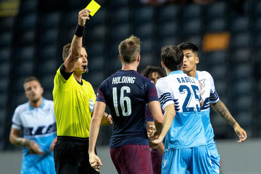 Rob Holding of Arsenal gets a yellow card from referee