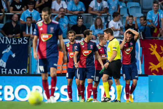 The referee holds a bottle which hit Anel Hadžić of