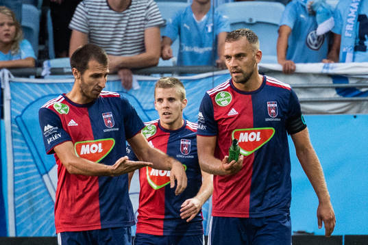 Roland Juhász holds a bottle which hit Anel Hadžić of