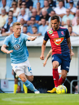 Anders Christiansen of Malmö FF chasing Anel Hadžić of