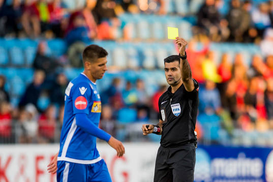 Emil Palsson of Sandefjord is shown a yellow card by rRohit