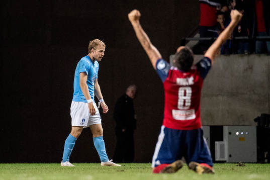 Oscar Lewicki of Malmö FF looks dejected while Anel Hadzic