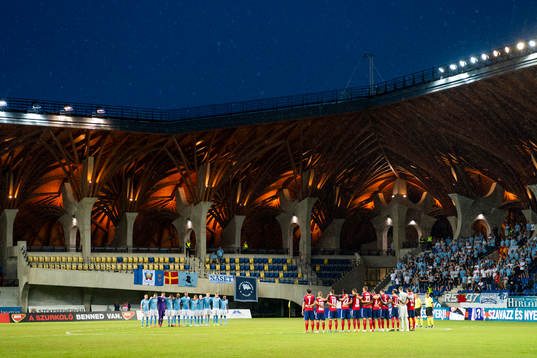 Teams line up for a silent minute