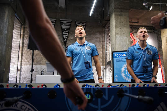 Anton Tinnerholm (L) plays foosball with teammates at a