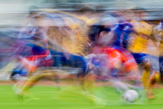 Players of both teams fight for the ball