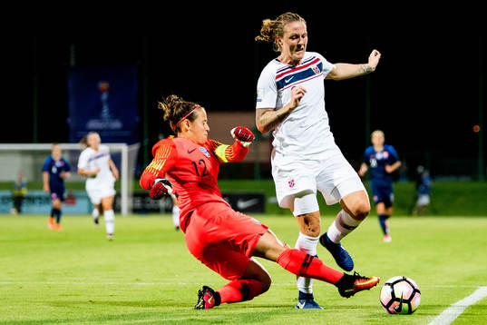 Isabell Herlovsen of Norway is being tackled by goalkeeper