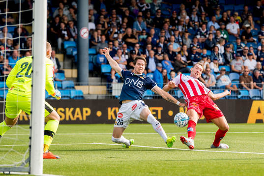 Lars Vilsvik of Strømsgodset tackles Magnar Ødegaard of