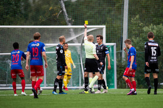Niels Vorthoren of Sandnes Ulf is shown a yellow card