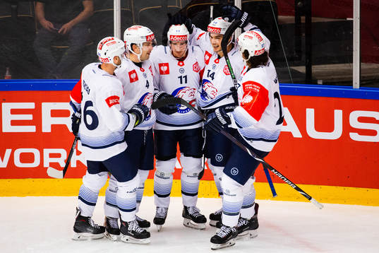Roman Cervenka (middle) celebrates with Patrick Geering and