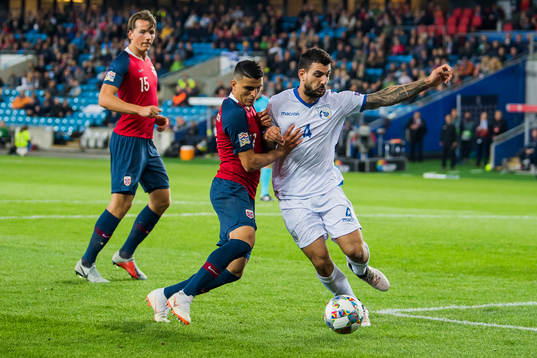 Mohamed Elyounoussi of Norway and Giorgos Merkis of Cyprus