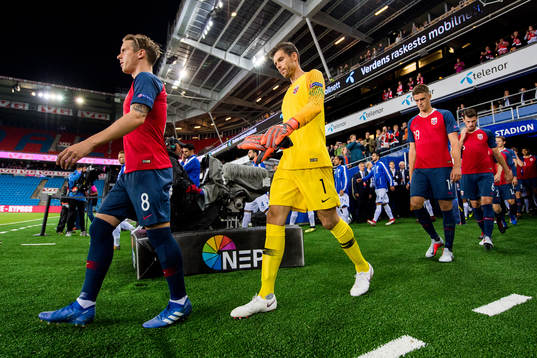 Stefan Johansen of Norway, goalkeeper Rune Almenning