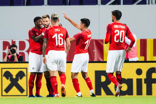 Guido Burgstaller of Austria celebrates with team mates