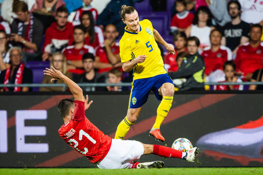 Stefan Lainer of Austria slide tackles Niklas Hult of Sweden
