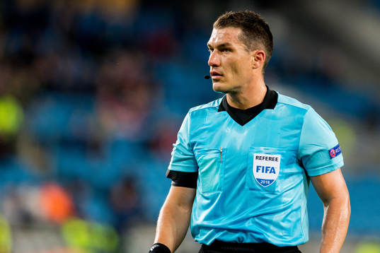 Referee István Kovács of Romania