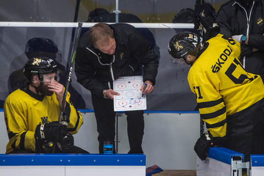 s spelare lyssnar på tränare Tomas Mitell