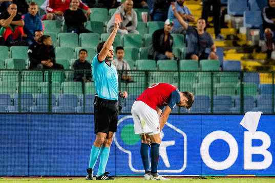 Referee Daniel Stefanski of Poland gives a red card to