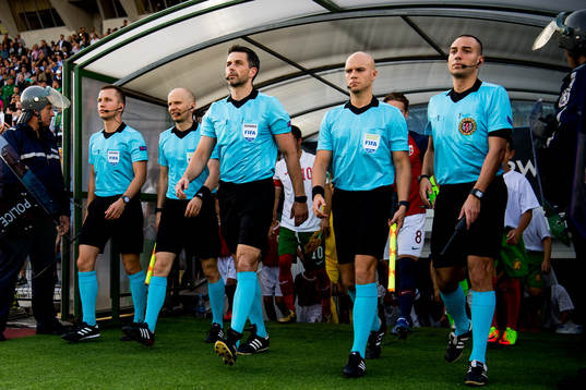 Referee Daniel Stefanski of Poland and the other referees
