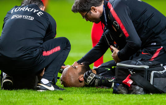 Goalkeeper Sinan Bolat of Turkey is in pain