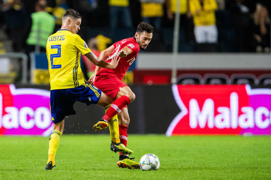 Mikael Lustig of Sweden and Hakan Calhanoglu of Turkey