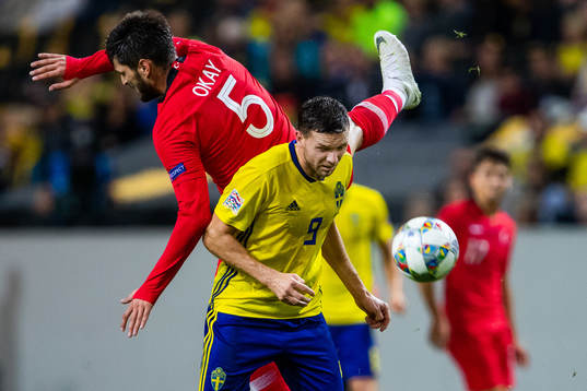 Okay Yokuslu of Turkey and Marcus Berg of Sweden