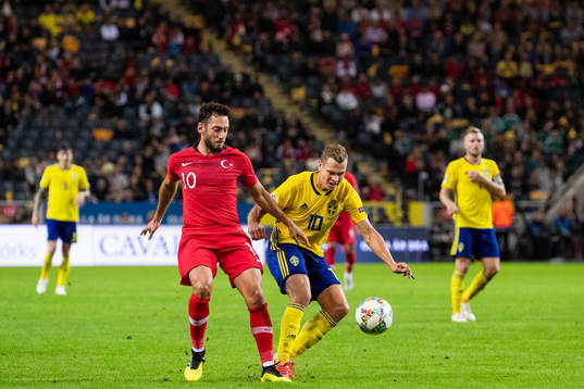 Hakan Calhanoglu of Turkey and Viktor Claesson of Sweden