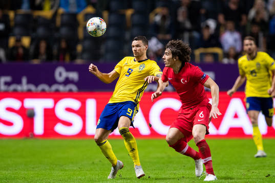 Marcus Berg of Sweden and Caglar Söyuncu of Turkey