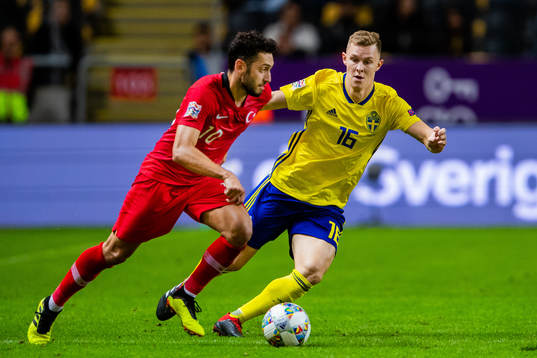 Hakan Calhanoglu of Turkey and Emil Krafth of Sweden