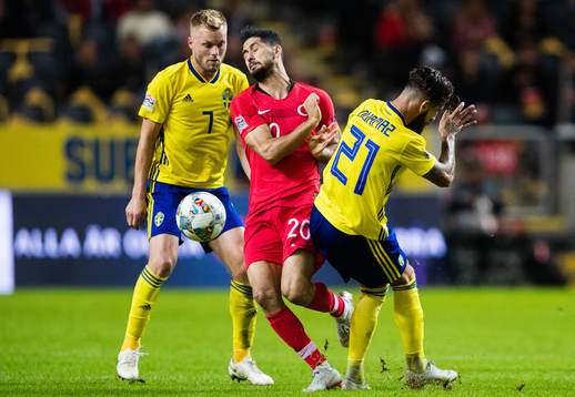 Sebastian Larsson and Jimmy Durmaz stops Emre Akbaba of