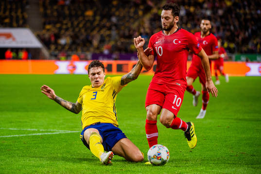 Victor Nilsson Lindelöf of Sweden and Hakan Calhanoglu of