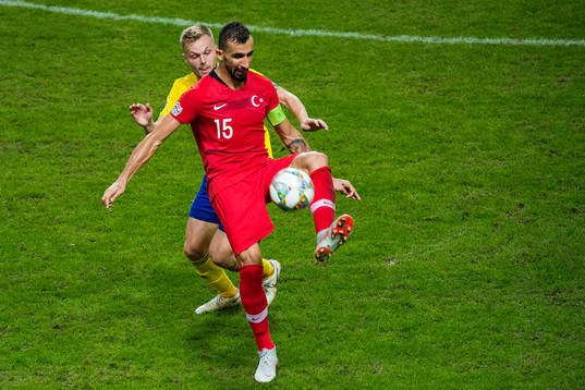 Sebastian Larsson of Sweden and Mehmet Topal of Turkey