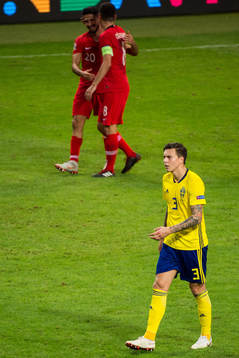 Victor Nilsson Lindelöf of Sweden looks dejected and Emre