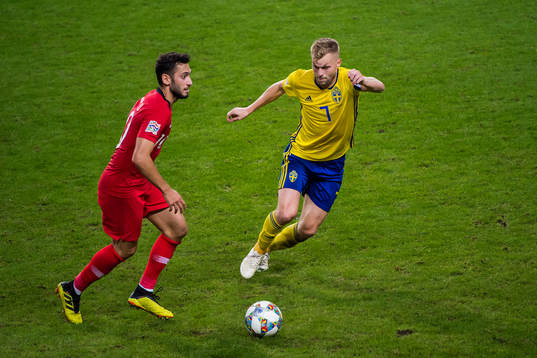 Hakan Calhanoglu of Turkey and Sebastian Larsson of Sweden