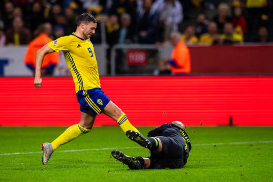 Marcus Berg of Sweden and goalkeeper Sinan Bolat of Turkey