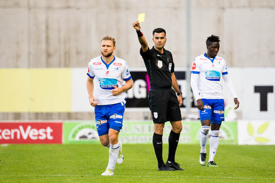 Sondre Tronstad of Haugesund is shown a yellow card by