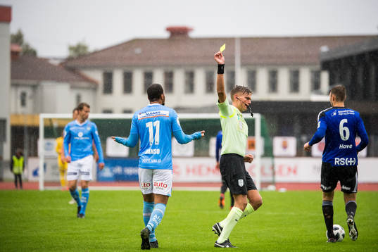 Erixon Danso of Sandnes Ulf is shown a yellow card by