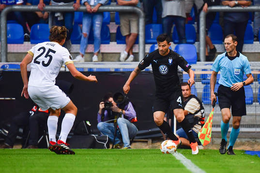 Sander Berge of Genk and Behrang Safari of Malmö FF