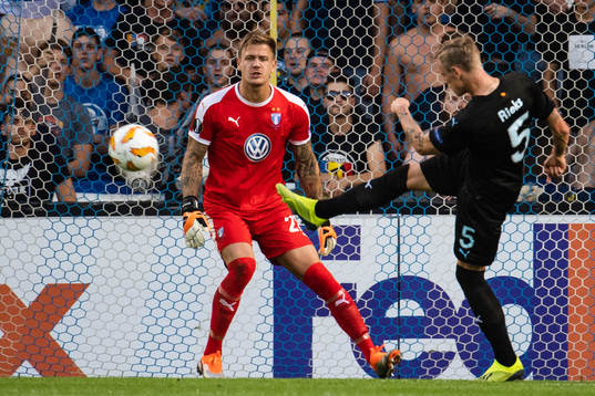 Sören Rieks clears the ball in front of goalkeeper Johan