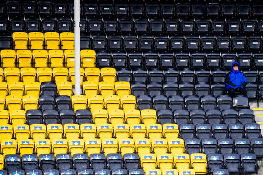 A spectator and empty seats