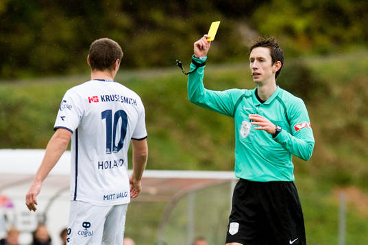 Tommy Høiland of Viking is shown a yellow card by Sivert